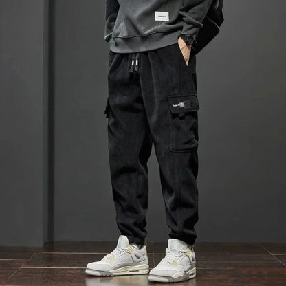 Men's fleece-lined tactical cargo pants with dual thigh pockets and ribbed ankle cuffs