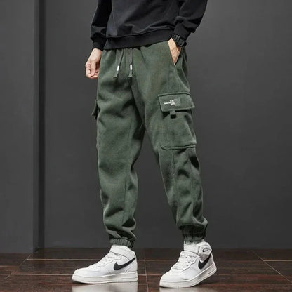 Men's fleece-lined tactical cargo pants with dual thigh pockets and ribbed ankle cuffs