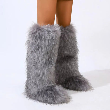 Knee-high faux fur slip-on boots with rounded toe and flared shaft in bold statement style