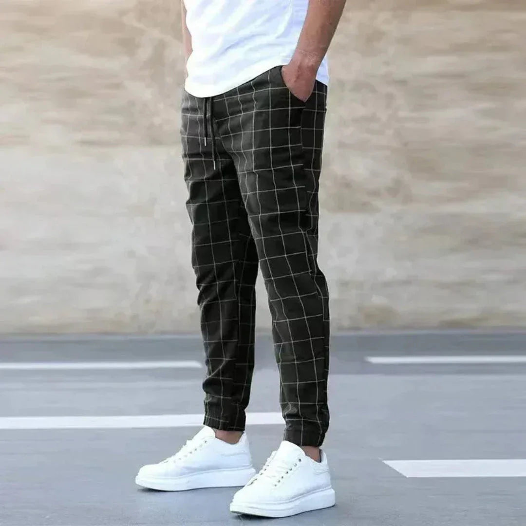 Men's checkered tapered jogger pants in black and white with ribbed cuffs and drawstring waist