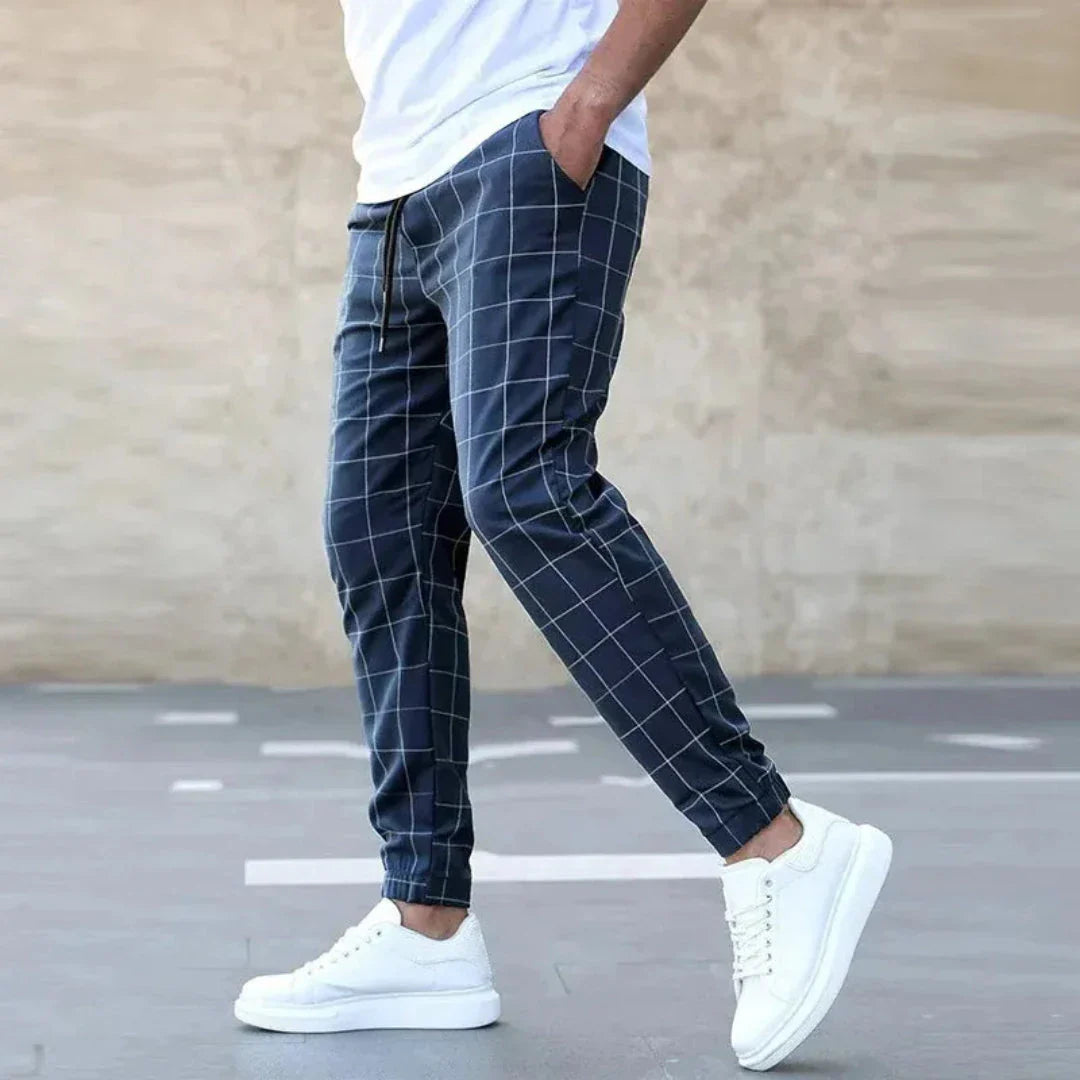 Checkered tapered jogger pants in black and white with ribbed cuffs and drawstring waistband