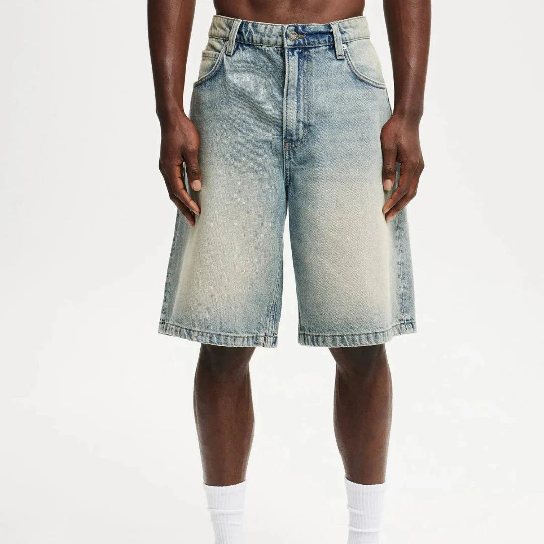 Men's relaxed fit knee-length denim shorts in vintage faded wash with classic 5-pocket design