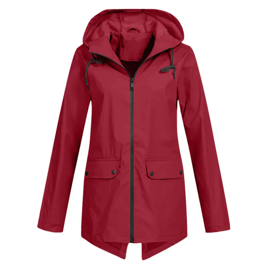 Women's waterproof hooded raincoat in neutral tone, modern slim silhouette with zippered front pockets