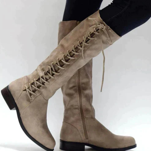 Black women's knee-high lace-up boots with sleek shaft silhouette for a modern edgy look