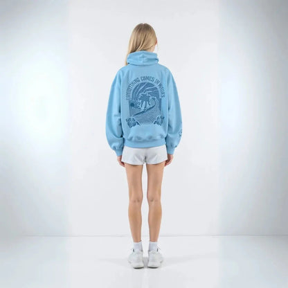 Wavlynn Kai oversized cream hoodie with palm tree print and Everything Comes in Waves motto graphic
