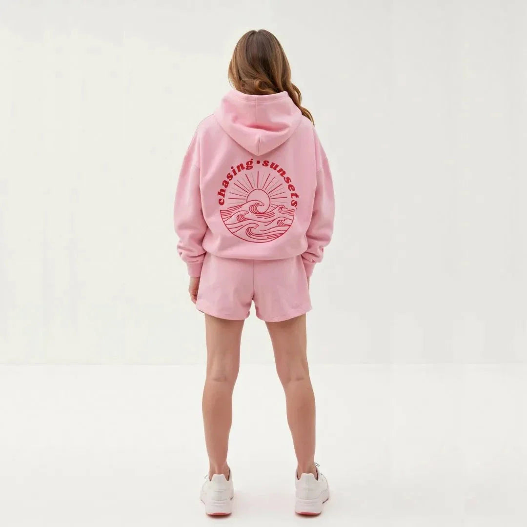 Wavlynn Kai oversized gray hoodie with tropical palm tree print and "Chasing Sunsets" wave motto