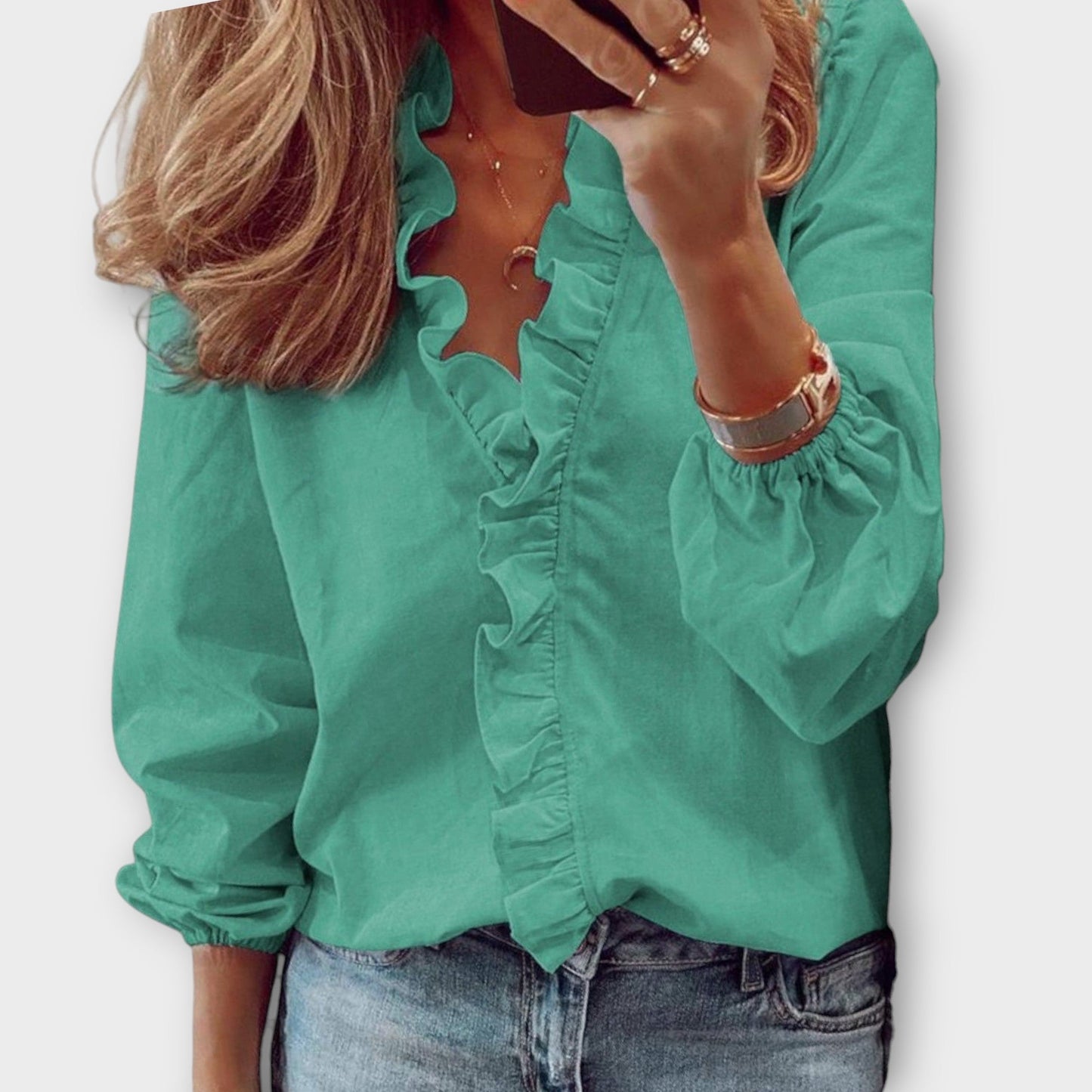 Women's ivory ruffle front V-neck long sleeve blouse with cascading ruffle trim detail