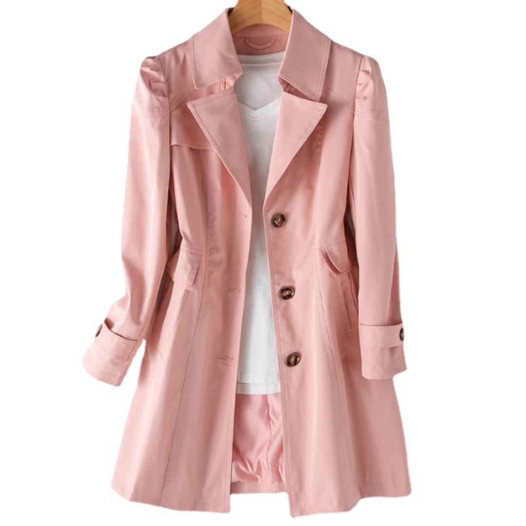 Beige double-breasted women's trench coat with tailored silhouette and structured button front closure