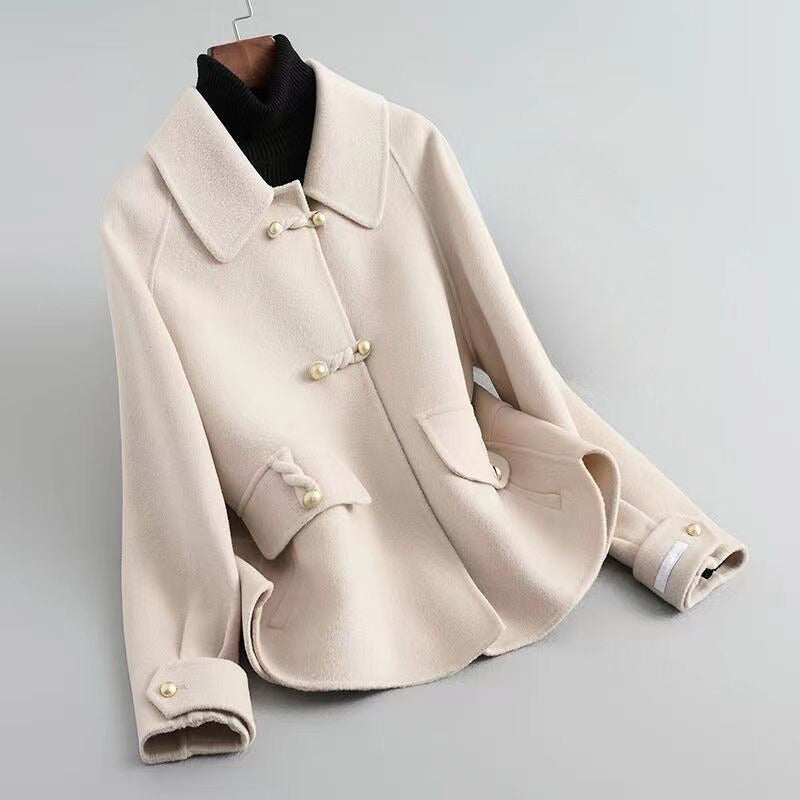 Ivory knit cotton-poly blend coat with lustrous pearl buttons, elegant Parisian-inspired silhouette
