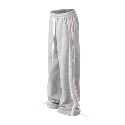 Striped loose-fit cotton sweatpants with floral lace detail, mid-rise drawstring waist, casual style