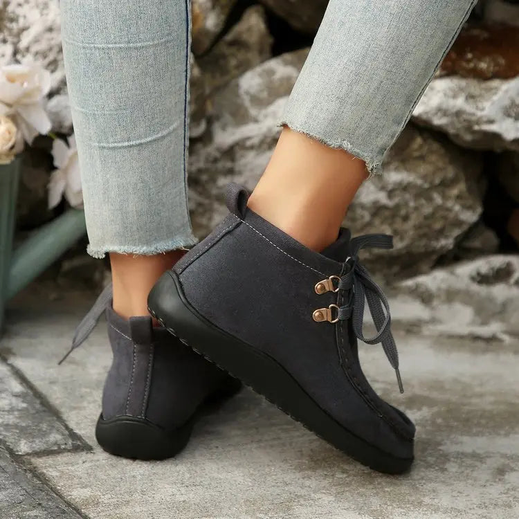 Women's brown faux suede lace-up winter boots with plush lining and cold-weather grip outsole