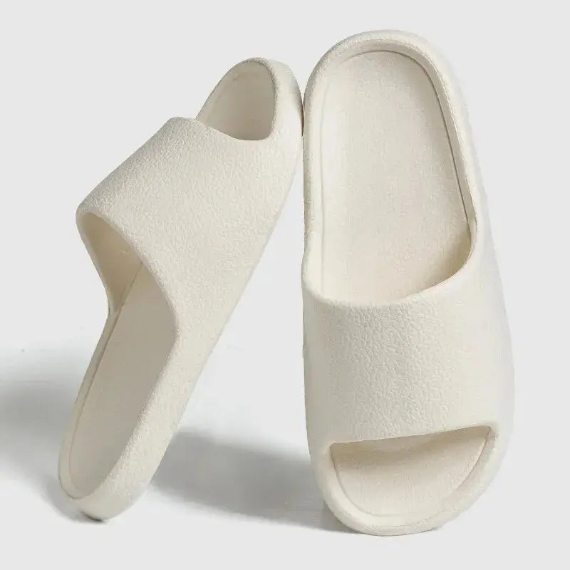 Women's lightweight EVA indoor slides in neutral tones with cushioned footbed and non-slip textured outsole