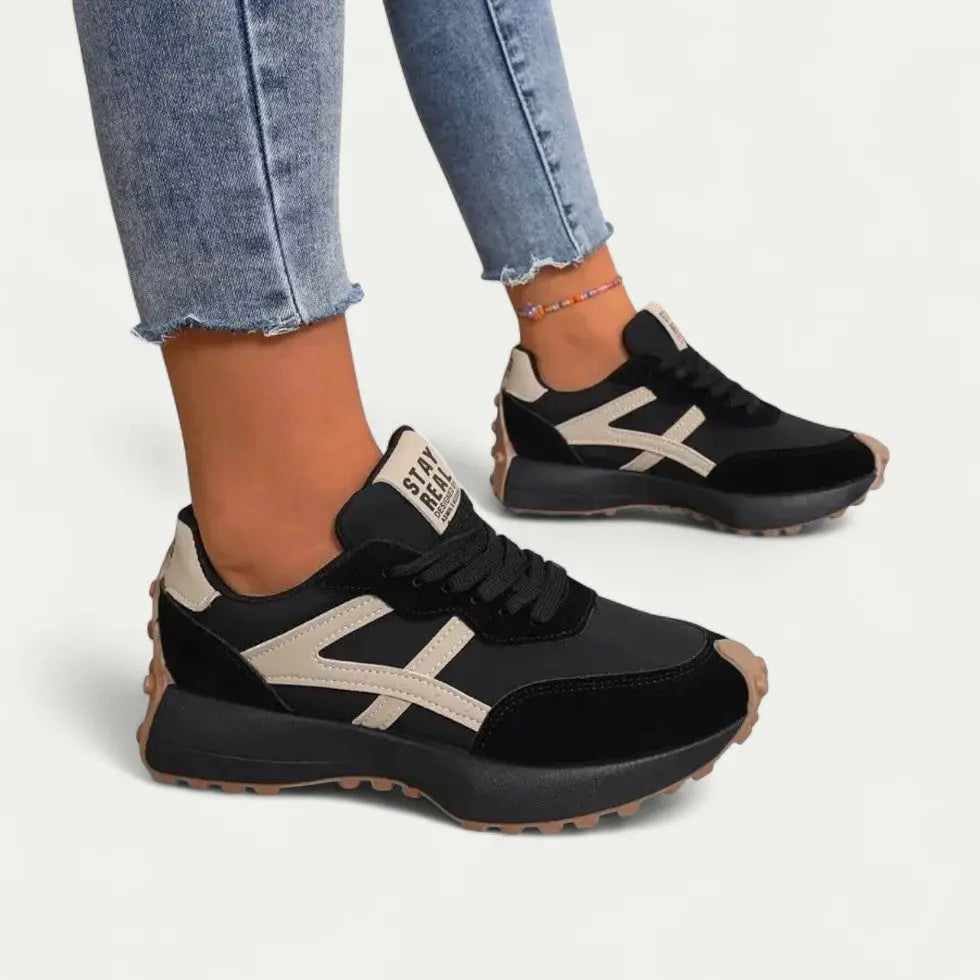 Women's white cushioned sneakers with sleek low-top silhouette and lightweight fashion-forward design