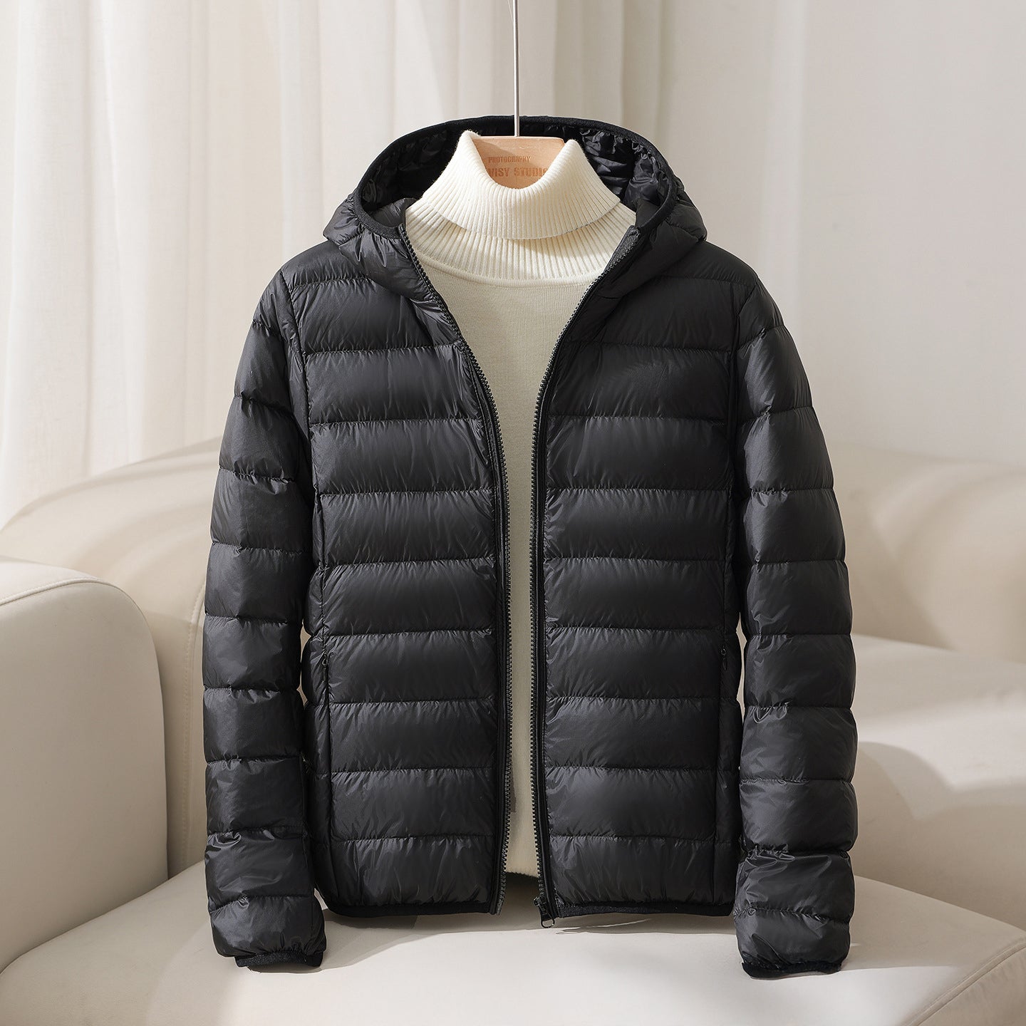 Lightweight hooded quilted down jacket in neutral tone, sleek silhouette with horizontal stitching