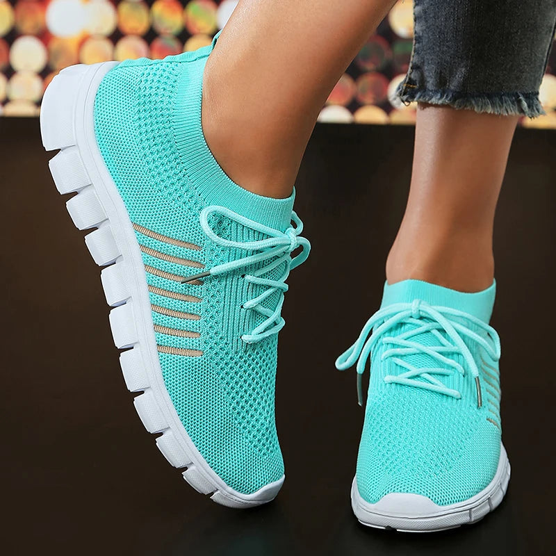 Women's white lightweight athletic sneakers with breathable mesh upper and casual chic silhouette