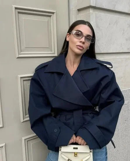 Lily cropped trench coat with wide-shoulder cut, lapel collar, and self-tie belt for modern sophistication