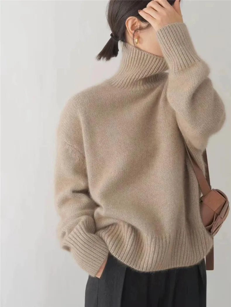 Cream oversized turtleneck sweater with ribbed details and drop shoulders for effortless cozy style
