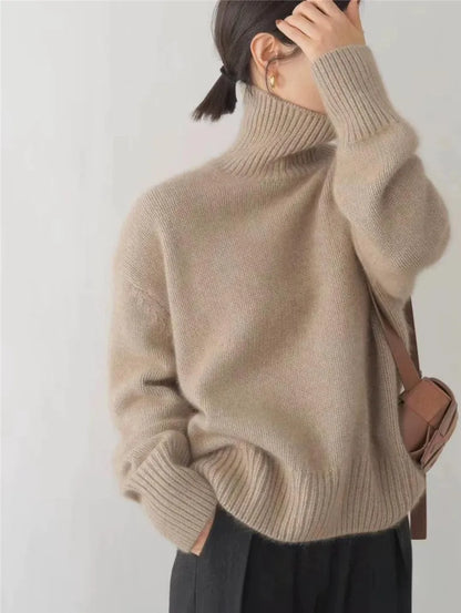 Cream oversized turtleneck sweater with ribbed details and drop shoulders for effortless cozy style