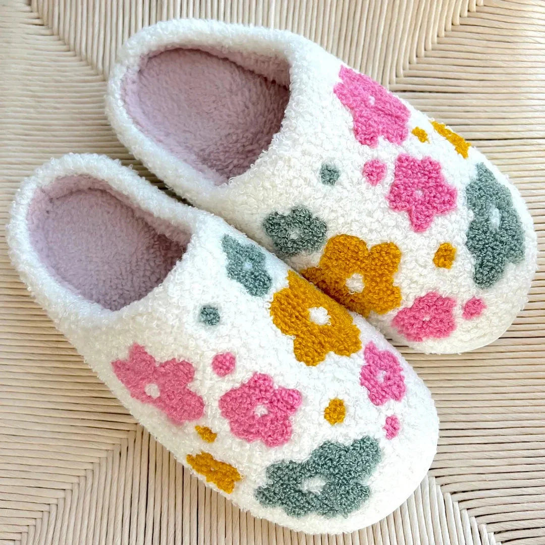 Women's cream sherpa slip-on slippers with pink plush interior and colorful pastel tufted floral detailing