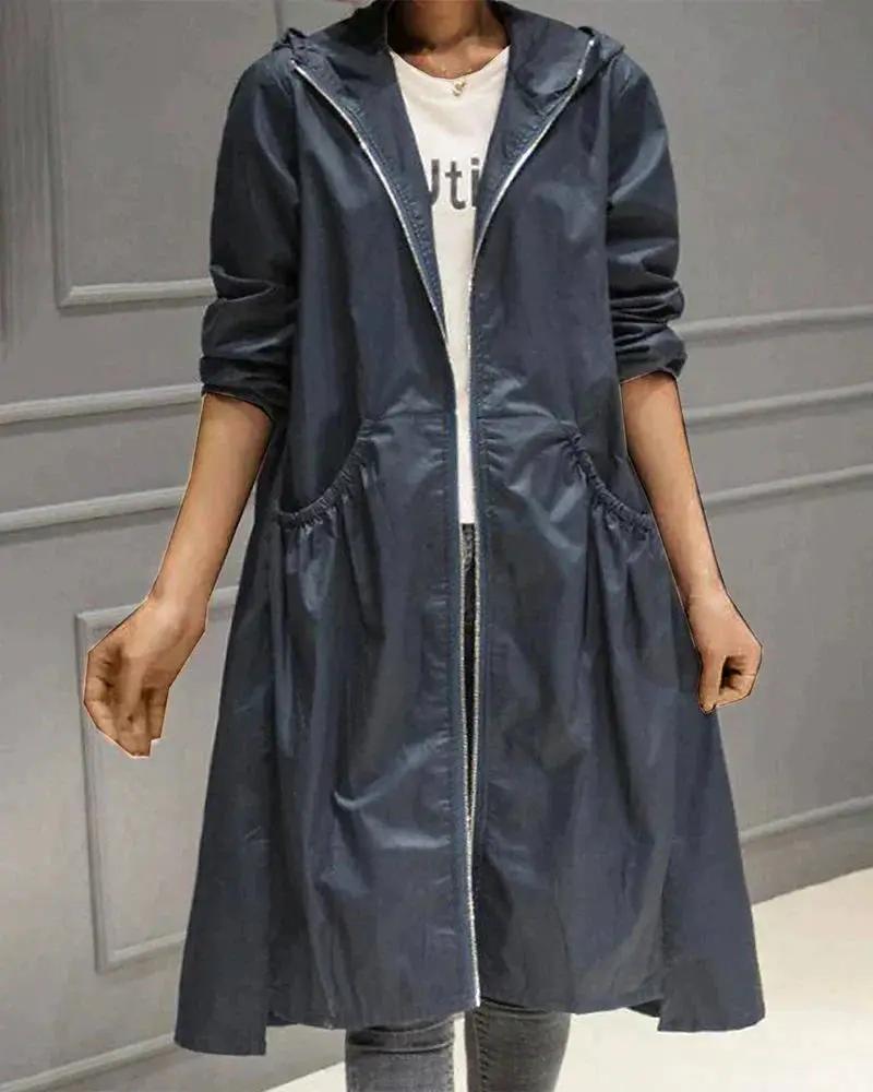 Women's long waterproof raincoat in neutral tone, full-zip closure with adjustable hood