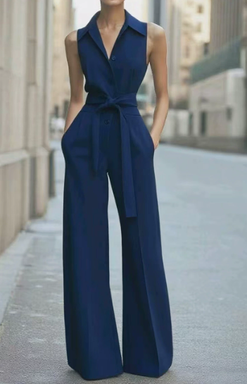 White sleeveless wide-leg belted jumpsuit with button-front bodice and floor-grazing formal trousers
