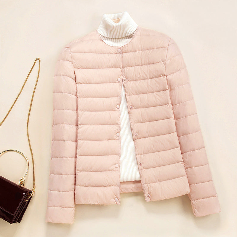 Lumen lightweight quilted down jacket in neutral tone with minimal round neckline and thin quilted insulation