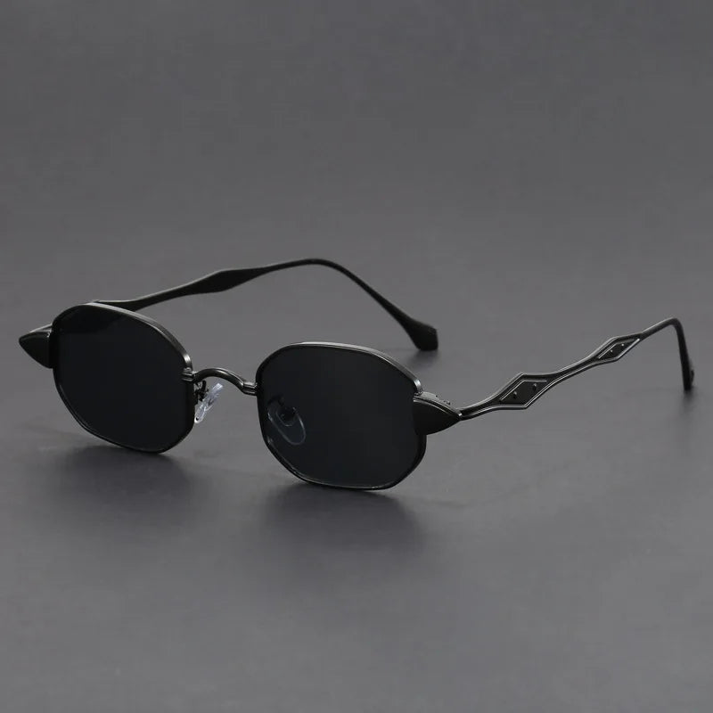 Bold black oval sunglasses with spiked pointed corners and sculpted metal arms for avant-garde retro glam