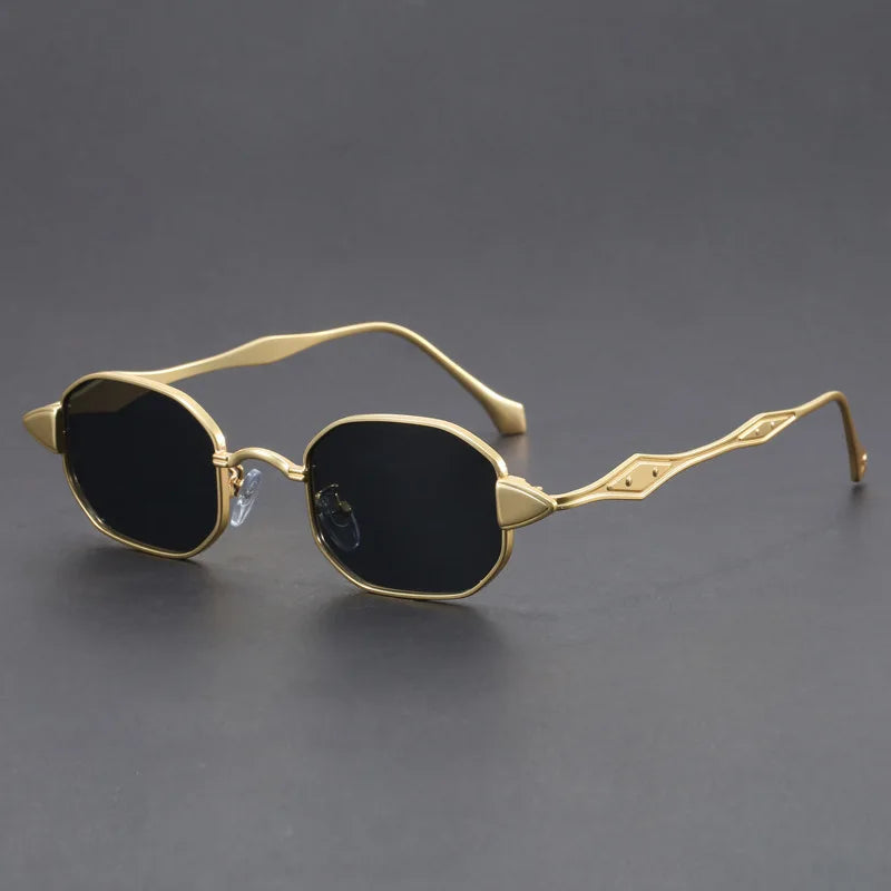 Bold black oval sunglasses with spiked lens corners and sculpted engraved metal arms for retro-glam style