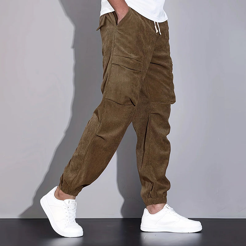 Men's brown corduroy cargo jogger pants with drawstring waist and multiple utility pockets