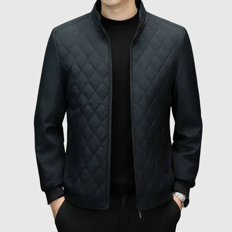 Men's navy diamond quilted bomber jacket with ribbed cuffs and full zip, modern minimalist style