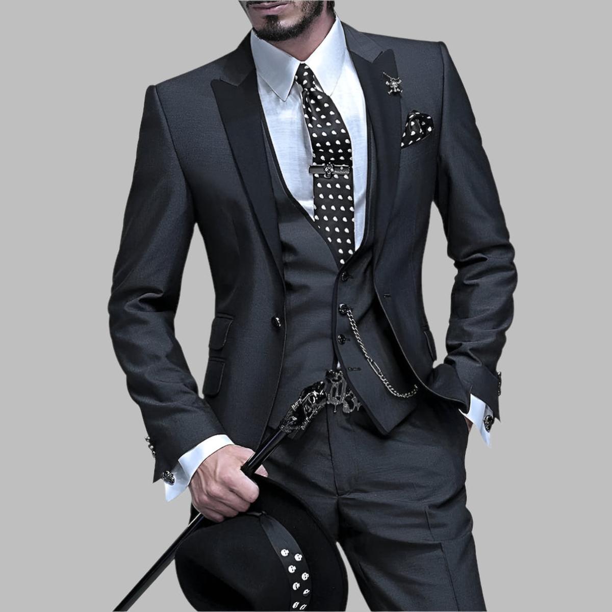 Emerald green men's three-piece wedding suit with black lapels and silver chain details