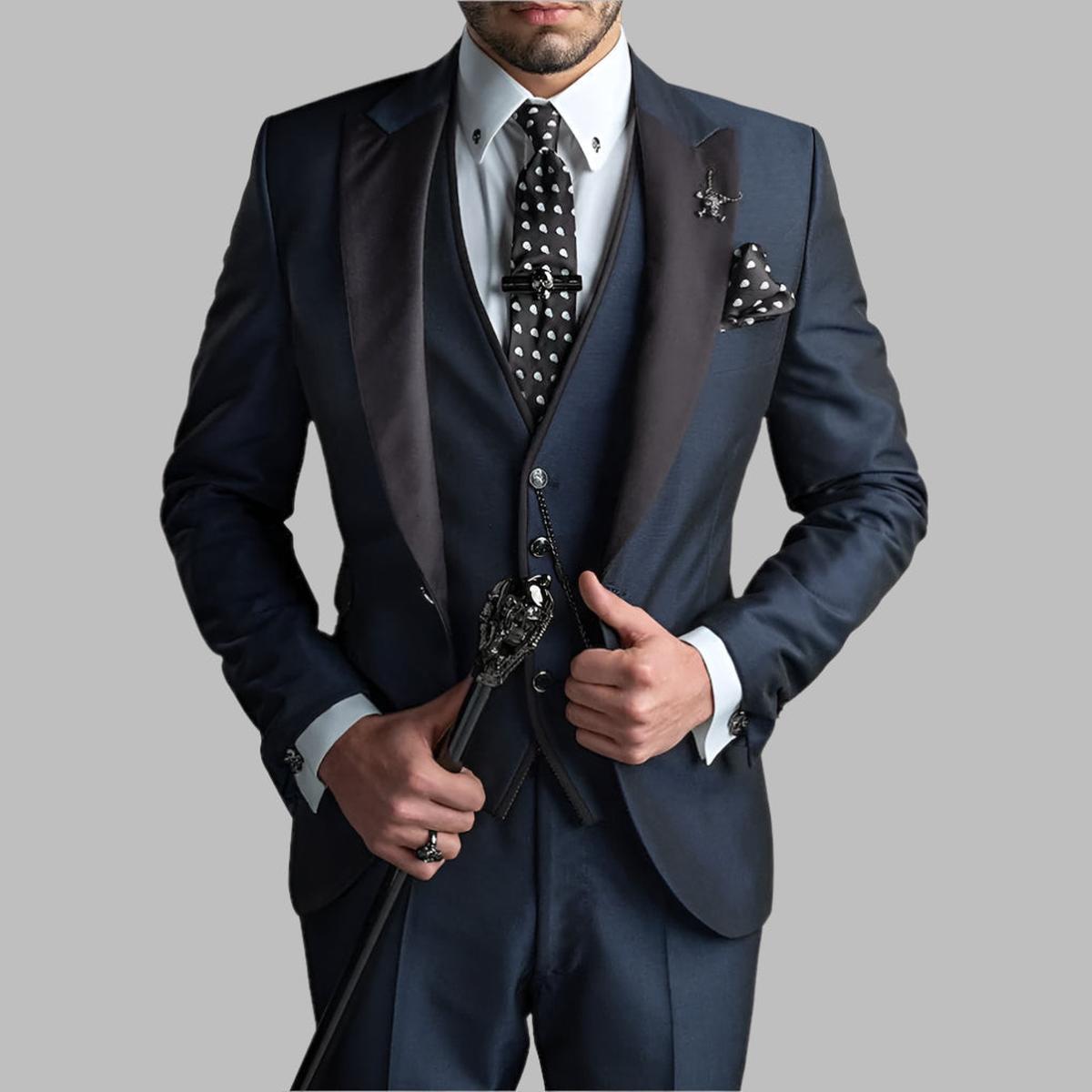 Emerald green men's three-piece wedding suit with black lapels and silver chain details