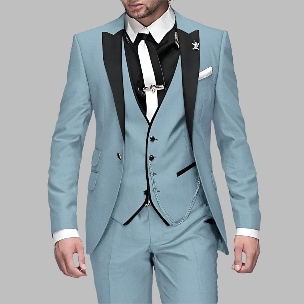 Emerald green men's three-piece wedding suit with black lapels and decorative silver chain details