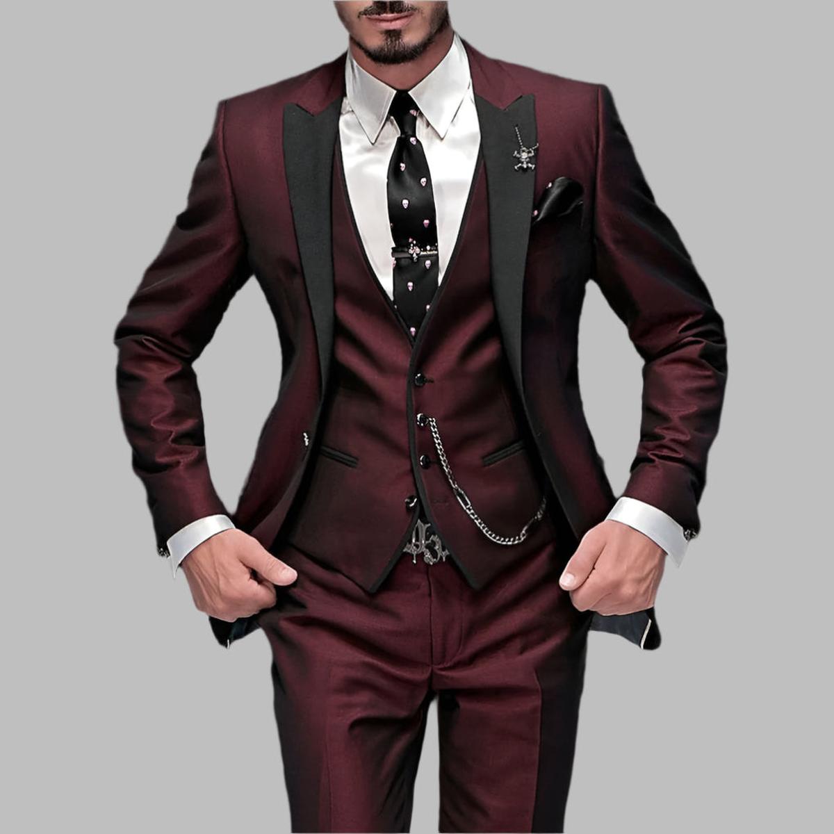 Emerald green men's three-piece wedding suit with black lapels and decorative silver chain details