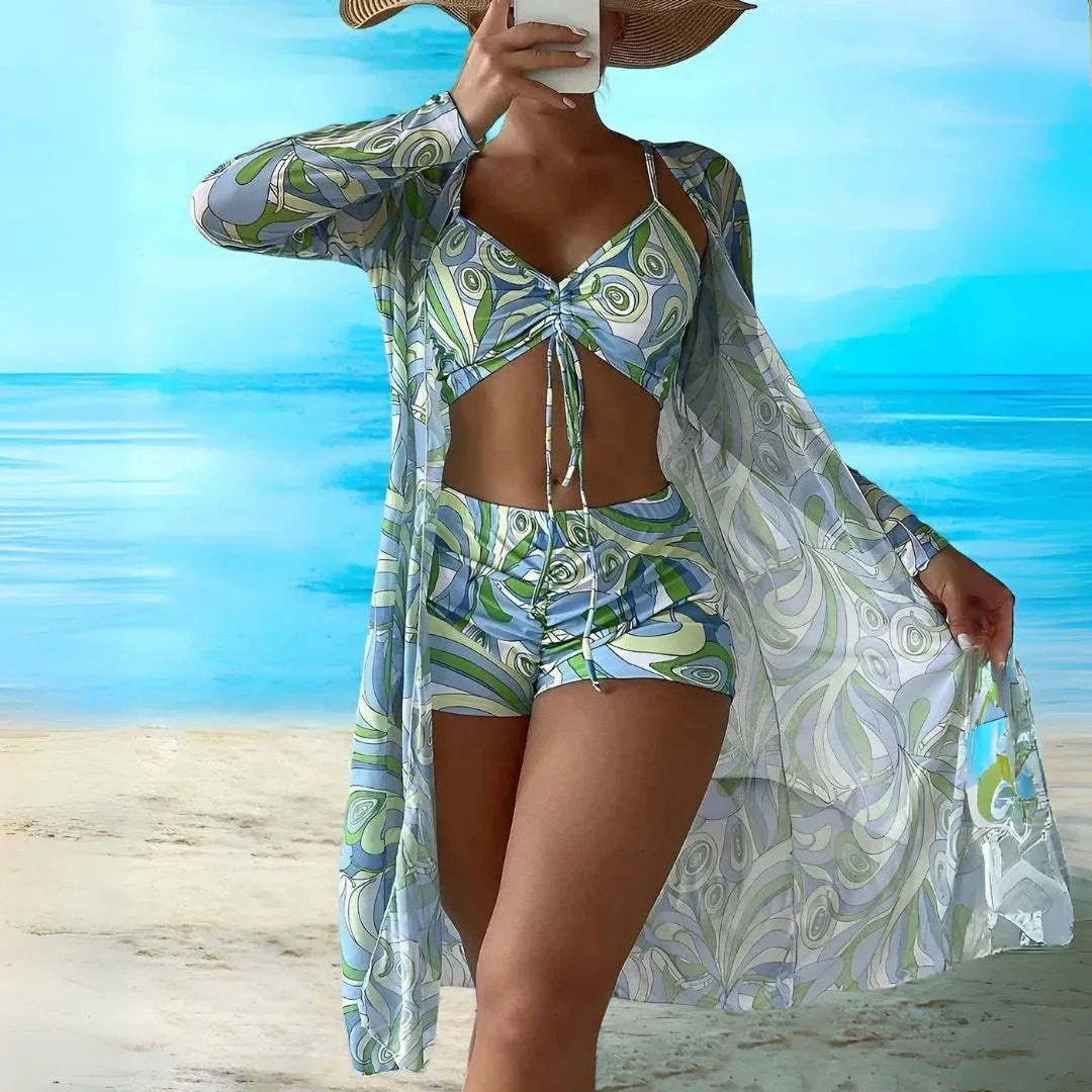Vibrant retro print 3-piece bikini set with ruched top, high-waisted shorts, and sheer longline cover-up