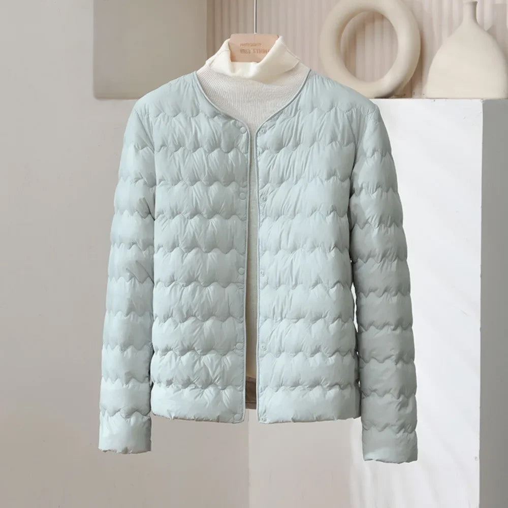 White collarless quilted down jacket with wave-pattern stitching, minimalist silhouette, lightweight insulation