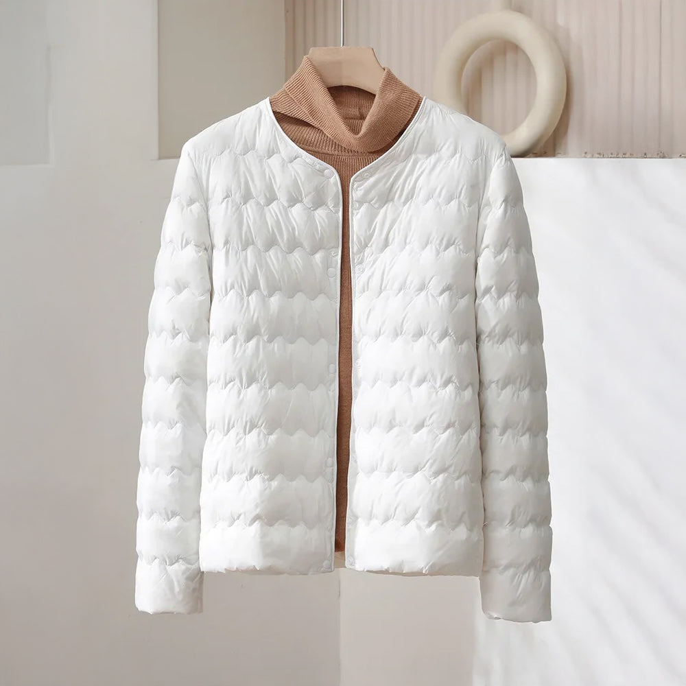 Minimalist collarless quilted down jacket with wave-pattern stitching, sleek nylon shell, lightweight warmth