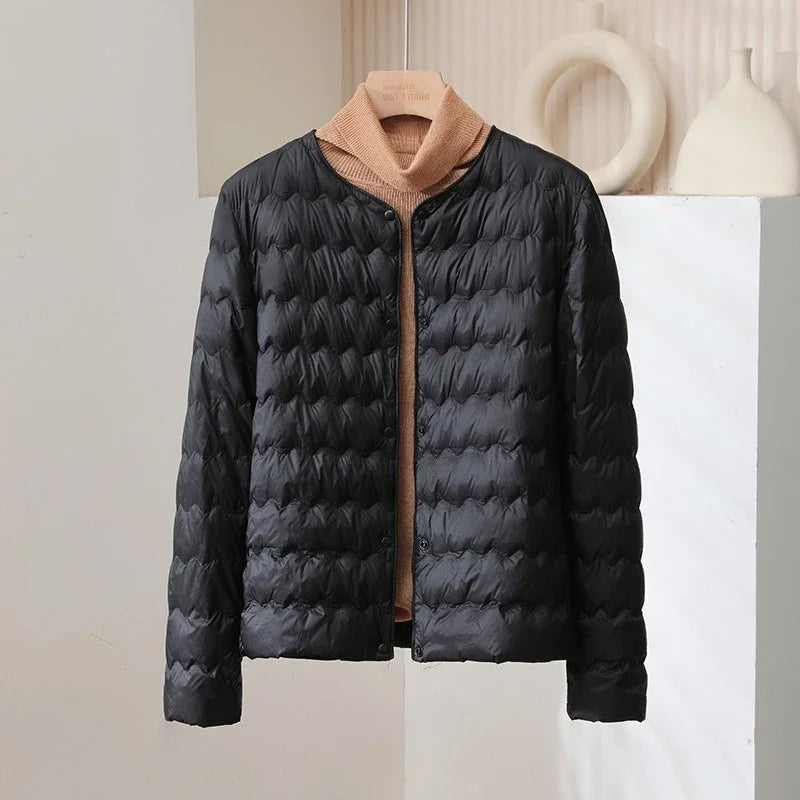 Minimalist collarless white quilted down jacket with wave-pattern stitching, sleek modern silhouette
