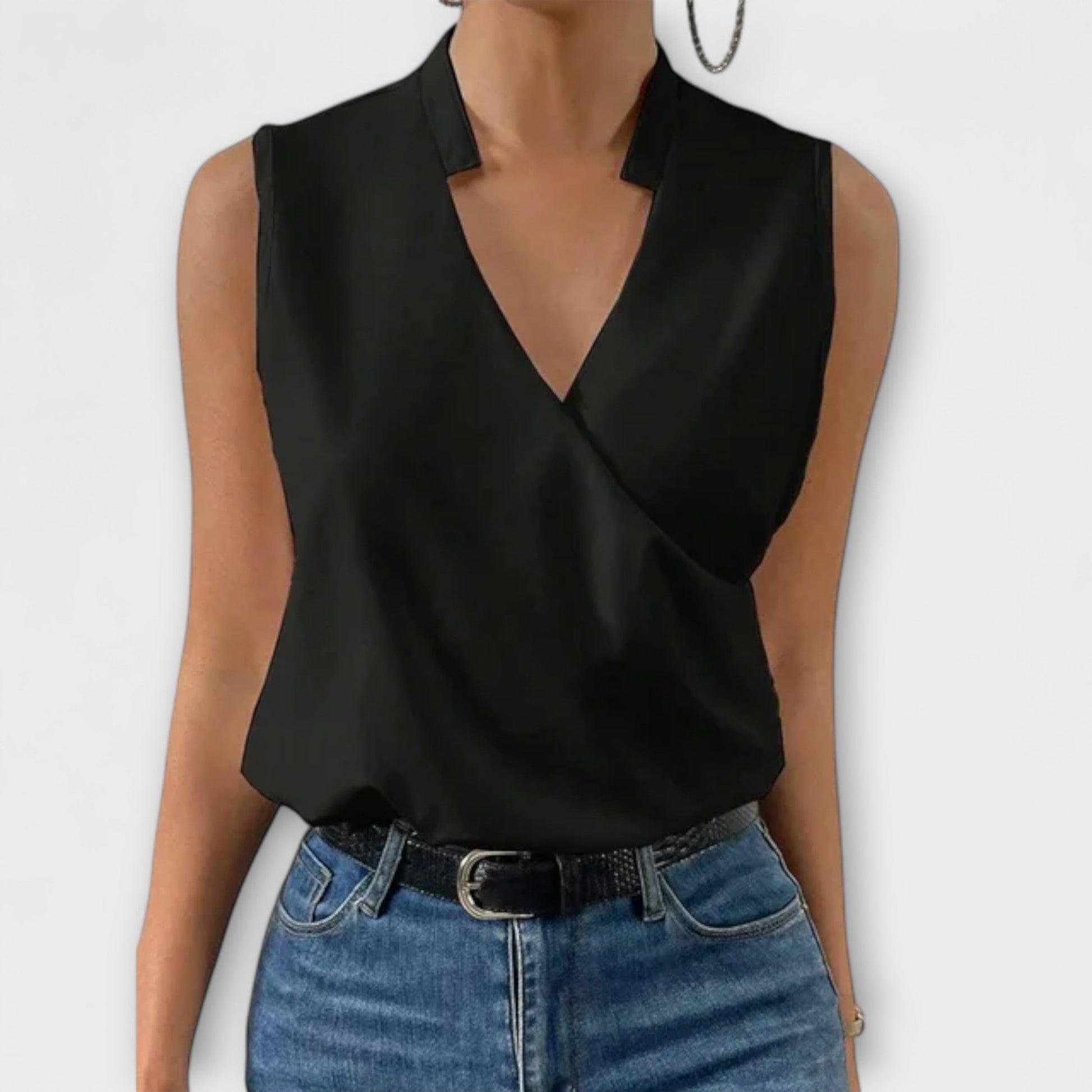 Women's sleeveless white wrap V-neck collared blouse with crossover drape, polished minimalist style