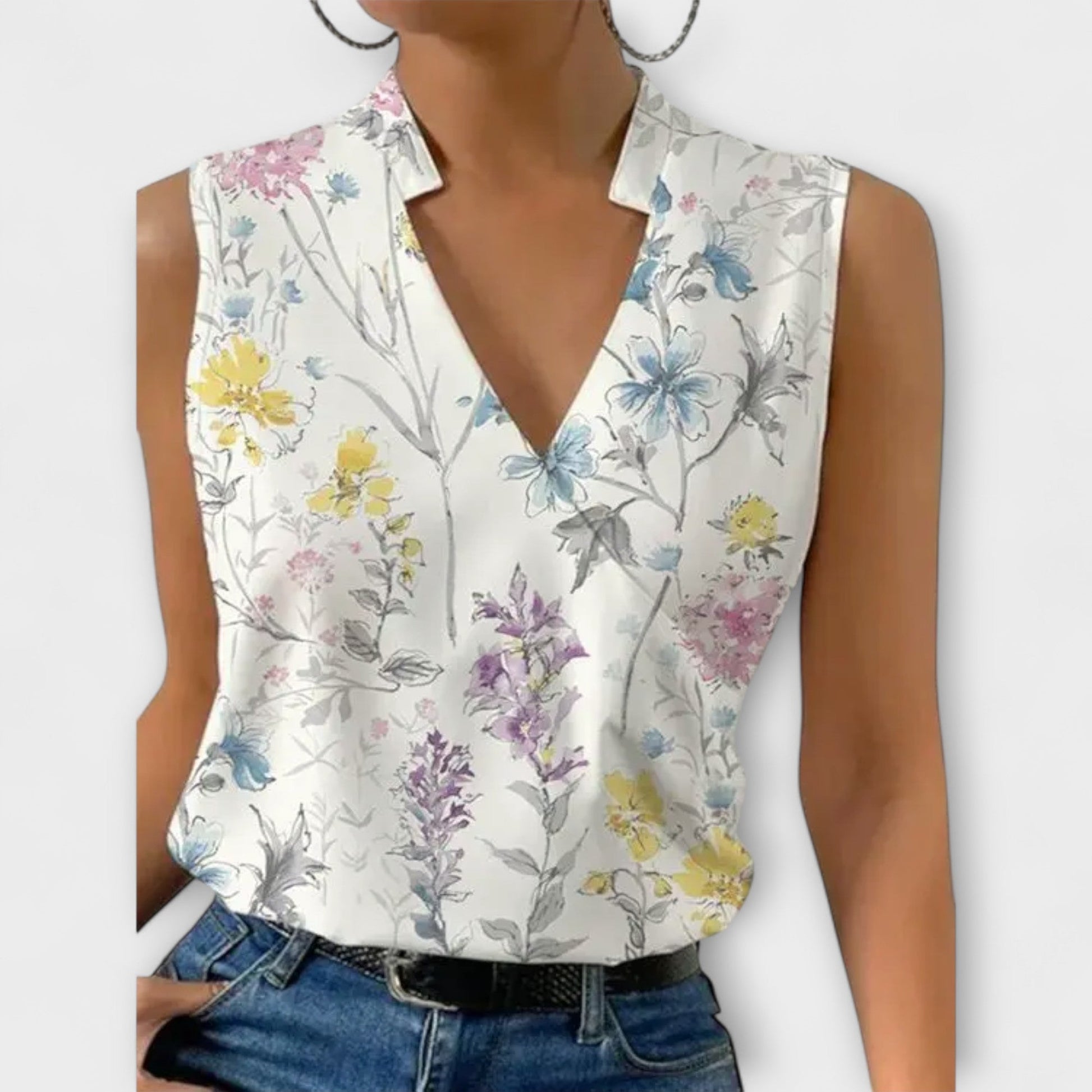 Women's sleeveless white wrap blouse with collared V-neckline and soft crossover drape