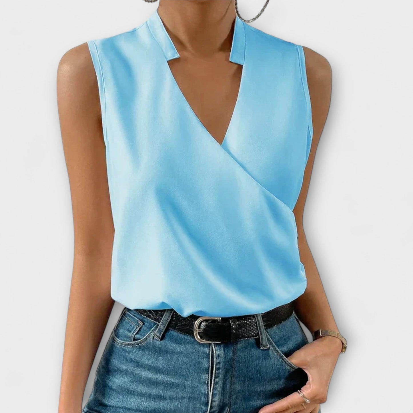 Women's sleeveless white wrap V-neck collared blouse with crossover drape and polished tailored fit