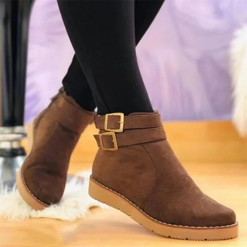 Women's black ankle boots with double buckle strap detail, sleek modern silhouette for everyday style
