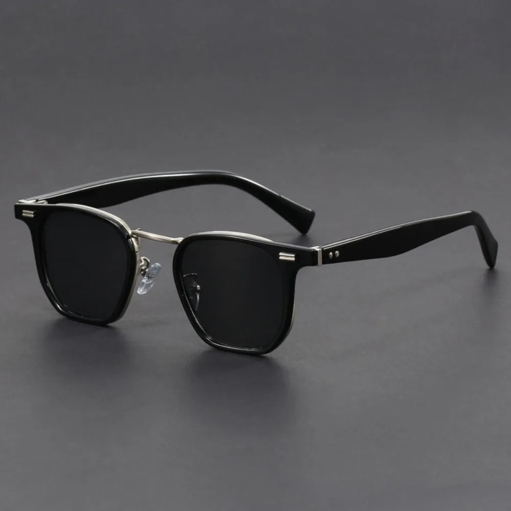 Black square acetate sunglasses with metal accents, dark lenses, and adjustable nose pads