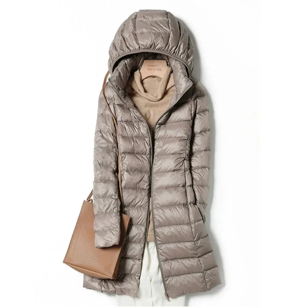 Women's black longline hooded puffer coat with sleek quilted finish and wind-resistant design
