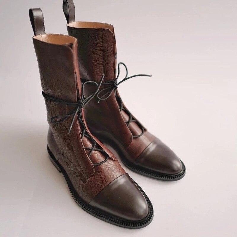 Women's black mid-calf lace-up combat boots with polished toe detail for chic everyday streetwear