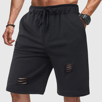 Men's gray distressed jogger shorts with relaxed fit, drawstring waist, and ripped detailing
