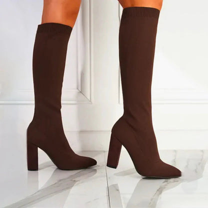 Women's black knee-high winter boots with sleek form-fitting shaft and elegant stiletto heel