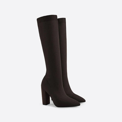 Women's black knee-high heeled winter boots with sleek form-fitting shaft for elegant cold-weather style