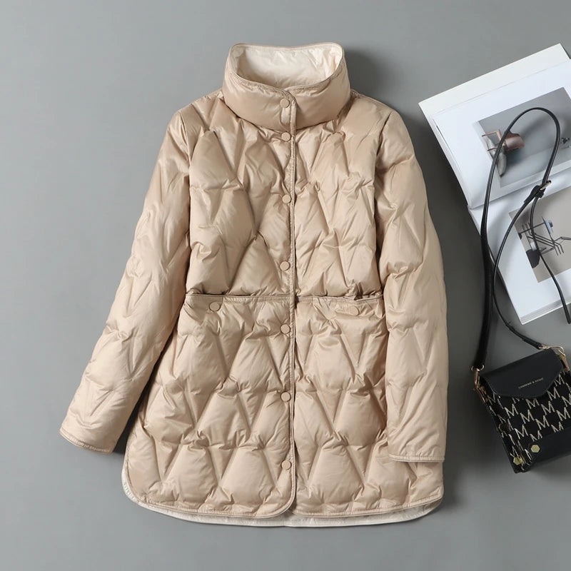 Women's mid-length quilted down jacket with diamond stitching, snap closures, and flattering waist silhouette