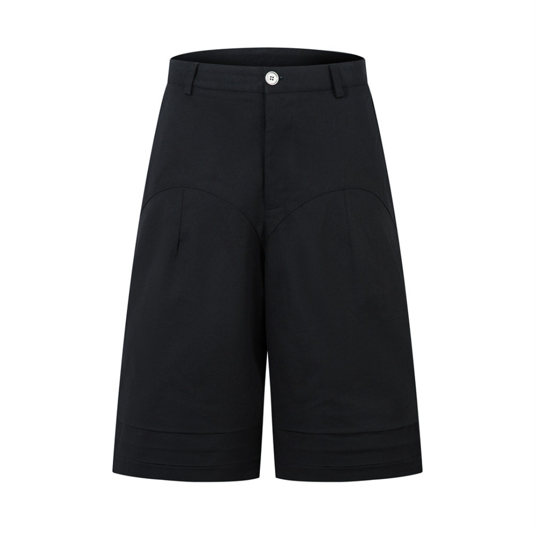 Beige wide leg pleated shorts with loose fit, mid-waist, zipper fly, and spacious pockets